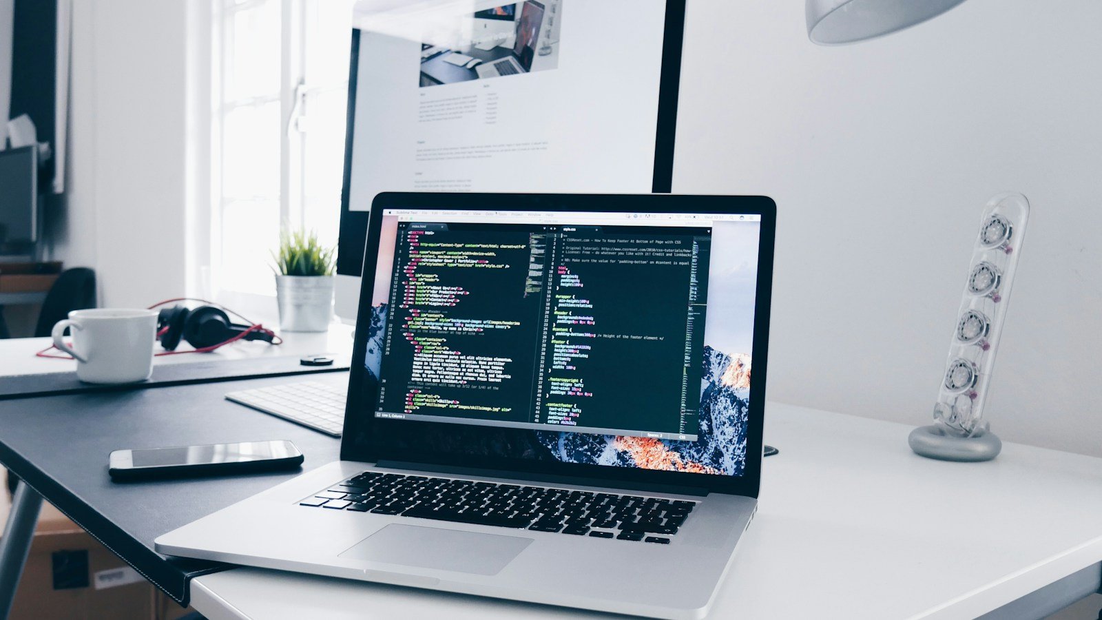 Laptop displaying code for a website conversion project